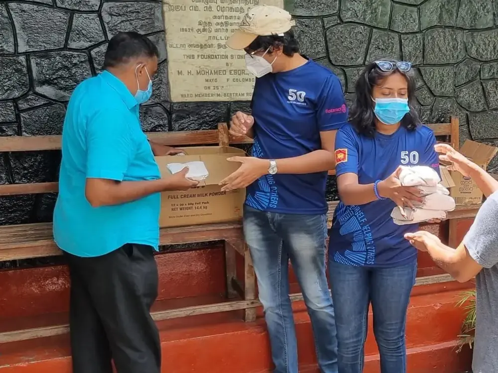 Members handing over meals during Community Meal Share