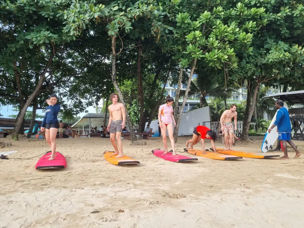 Escape to Paradise participants learning to surf