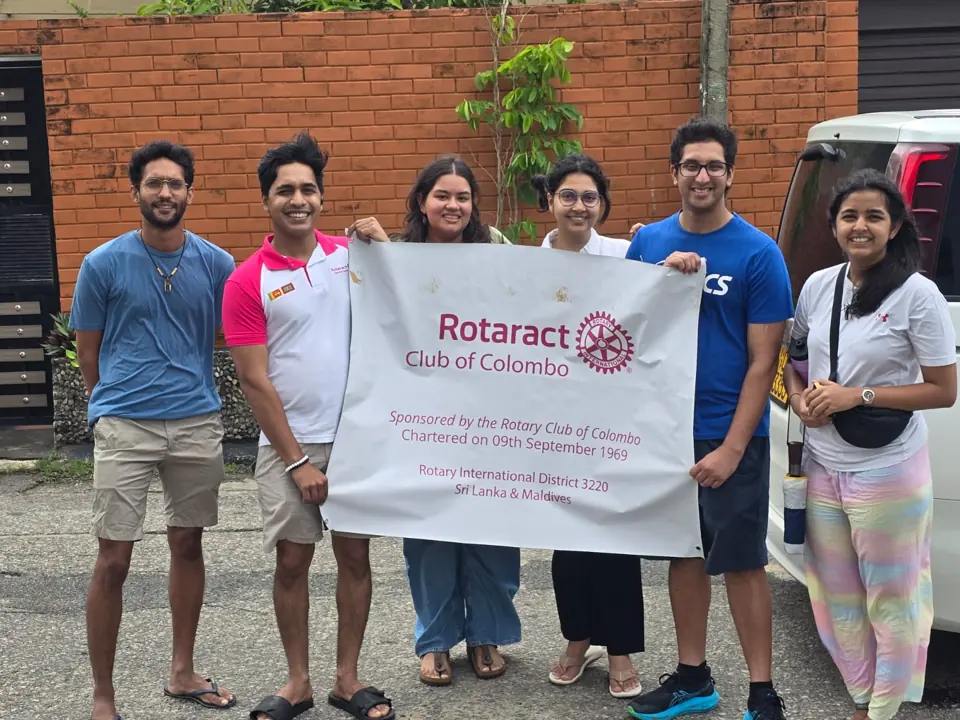 Members with the club banner at a food donation drive