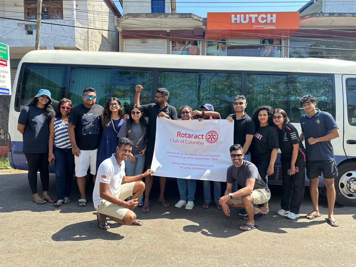 Members with the club banner beside the Charity Bus