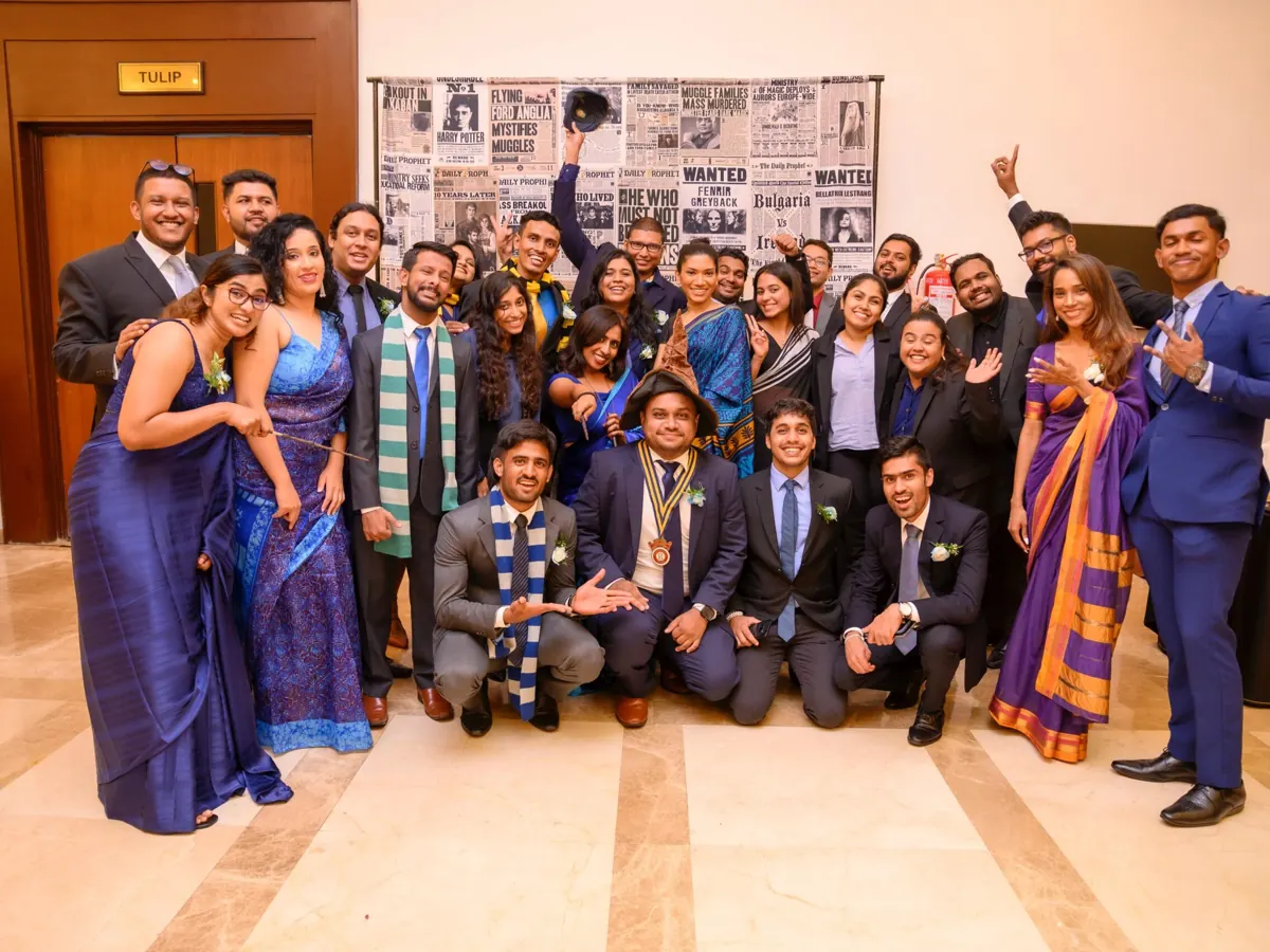 Club members in formal wear at an installation ceremony
